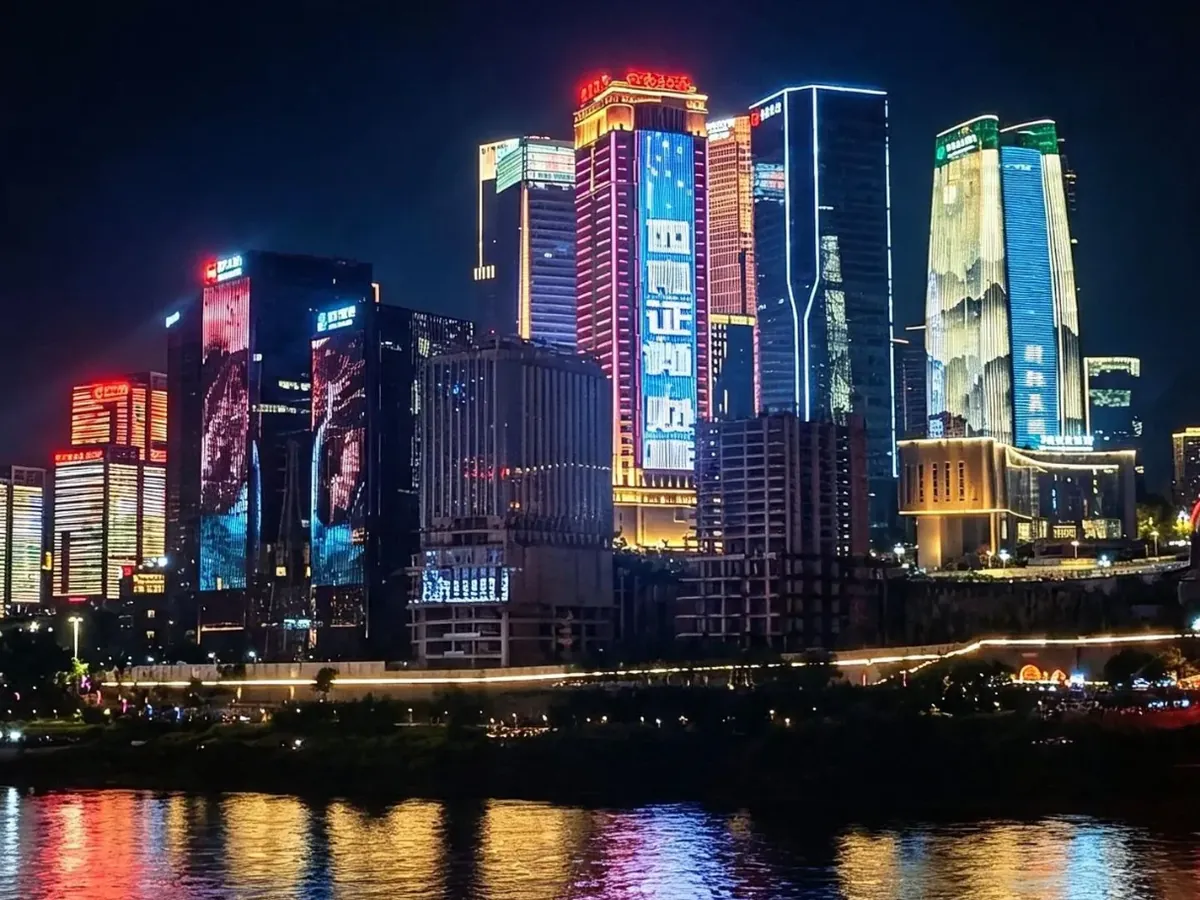 Chongqing's towers lit up at night and reflected in the river