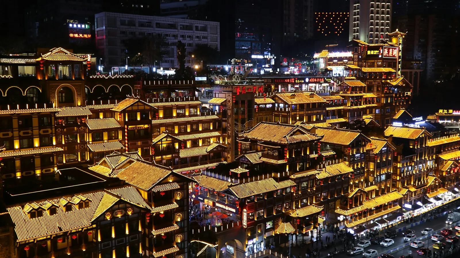 Illuminated riverside buildings and roads in Chongqing at night