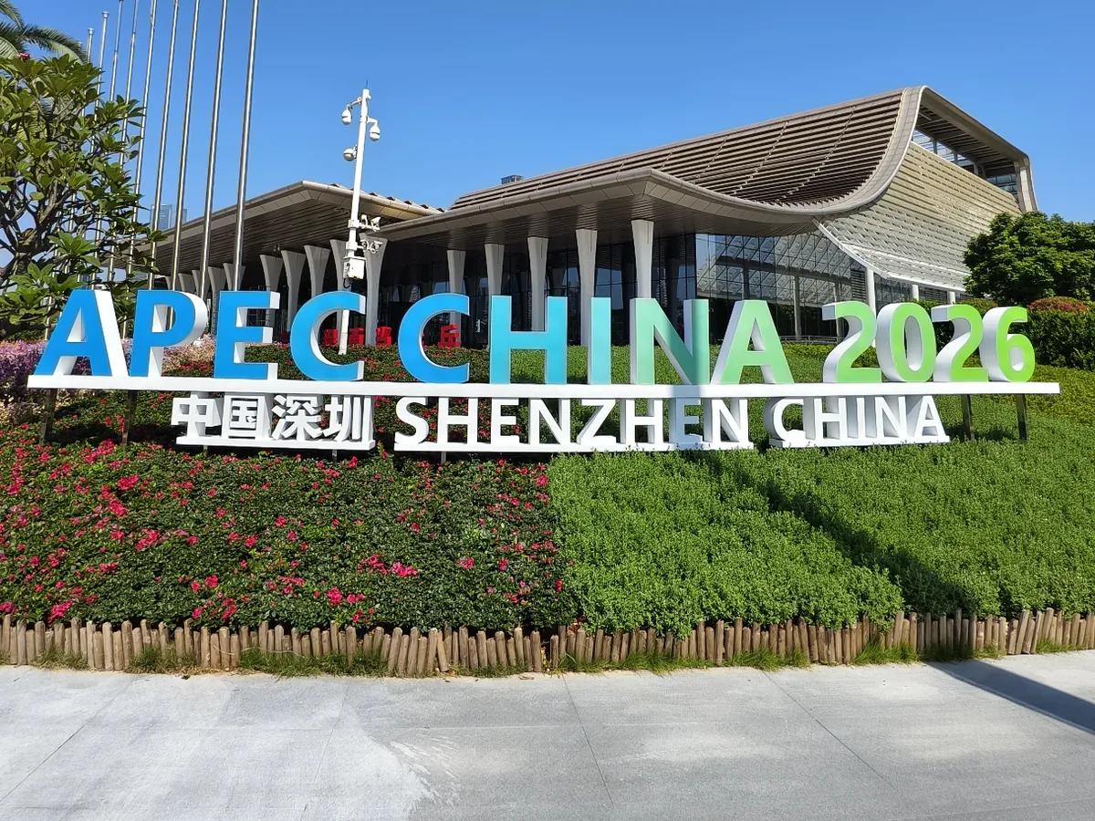Qianhai International Convention Center exterior behind an APEC China 2026 sign in Shenzhen