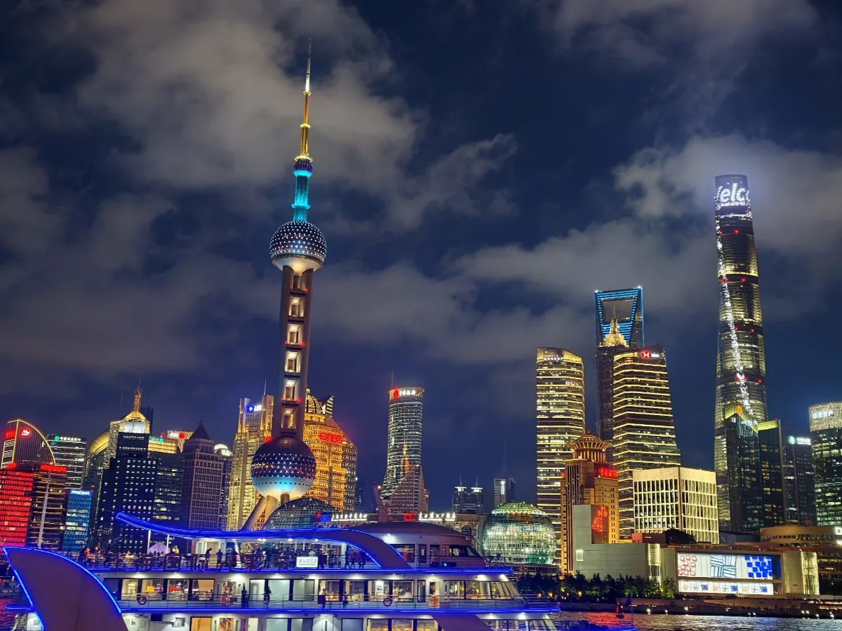 An evening river cruise passing the lit Pudong skyline, a typical first night on the Bund during a short Shanghai stopover