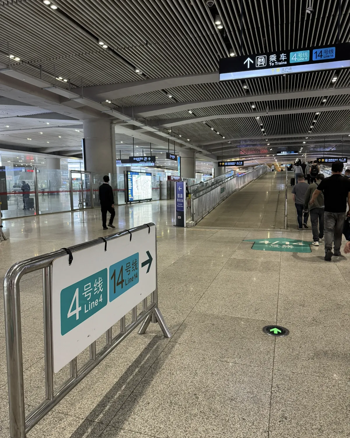 Signs inside Xi'an North Railway Station pointing to Metro Lines 4 and 14